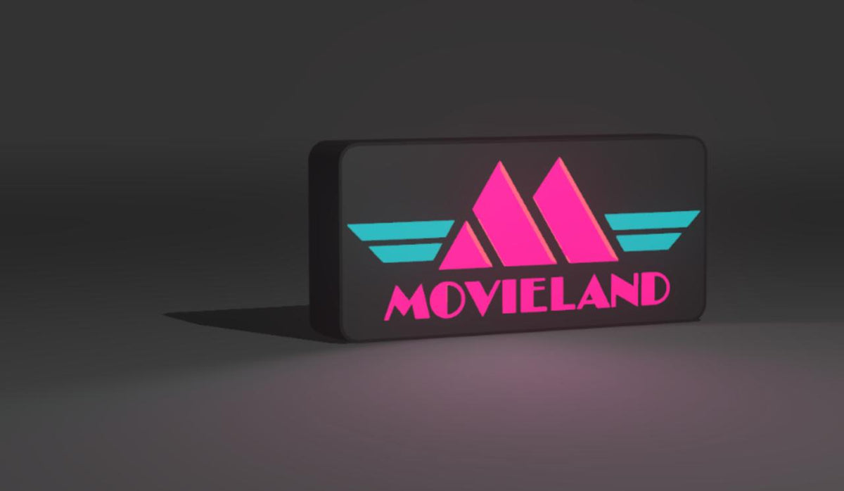 Movieland video store LED light-up sign glowing pink and teal on a matte black face