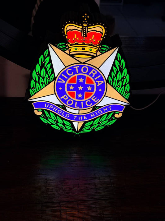 Victoria Police LED light-up sign glowing in a darkened room - VIC police badge wall art