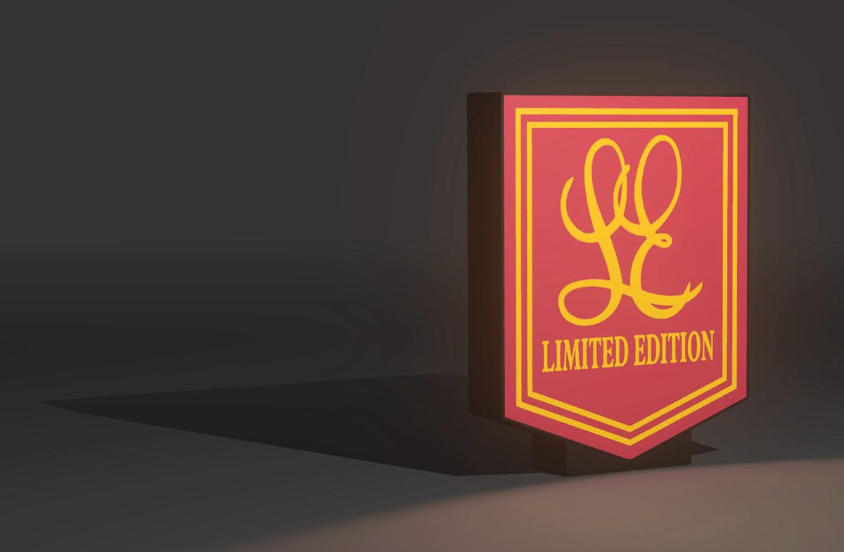 Holden HX LE front grille badge — gold LE script on red limited edition shield