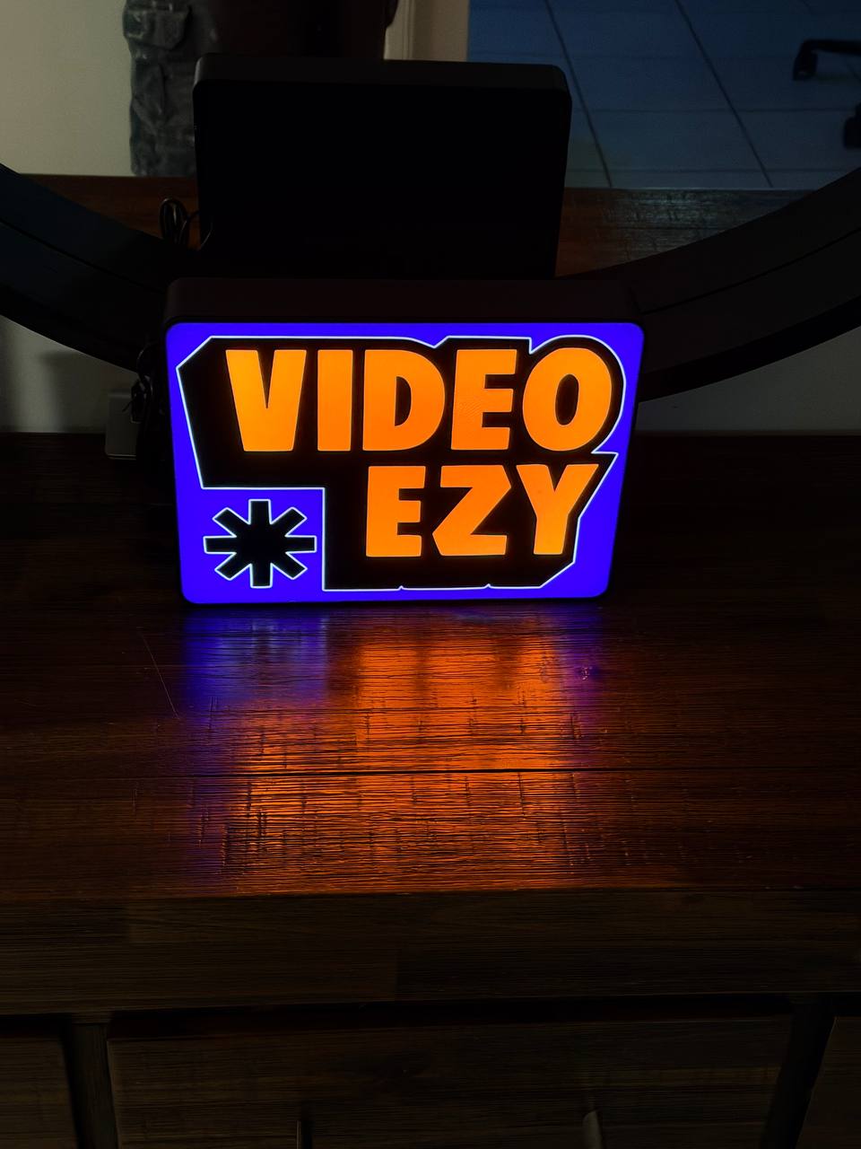 Video Ezy LED sign - blue background, on desk wide shot